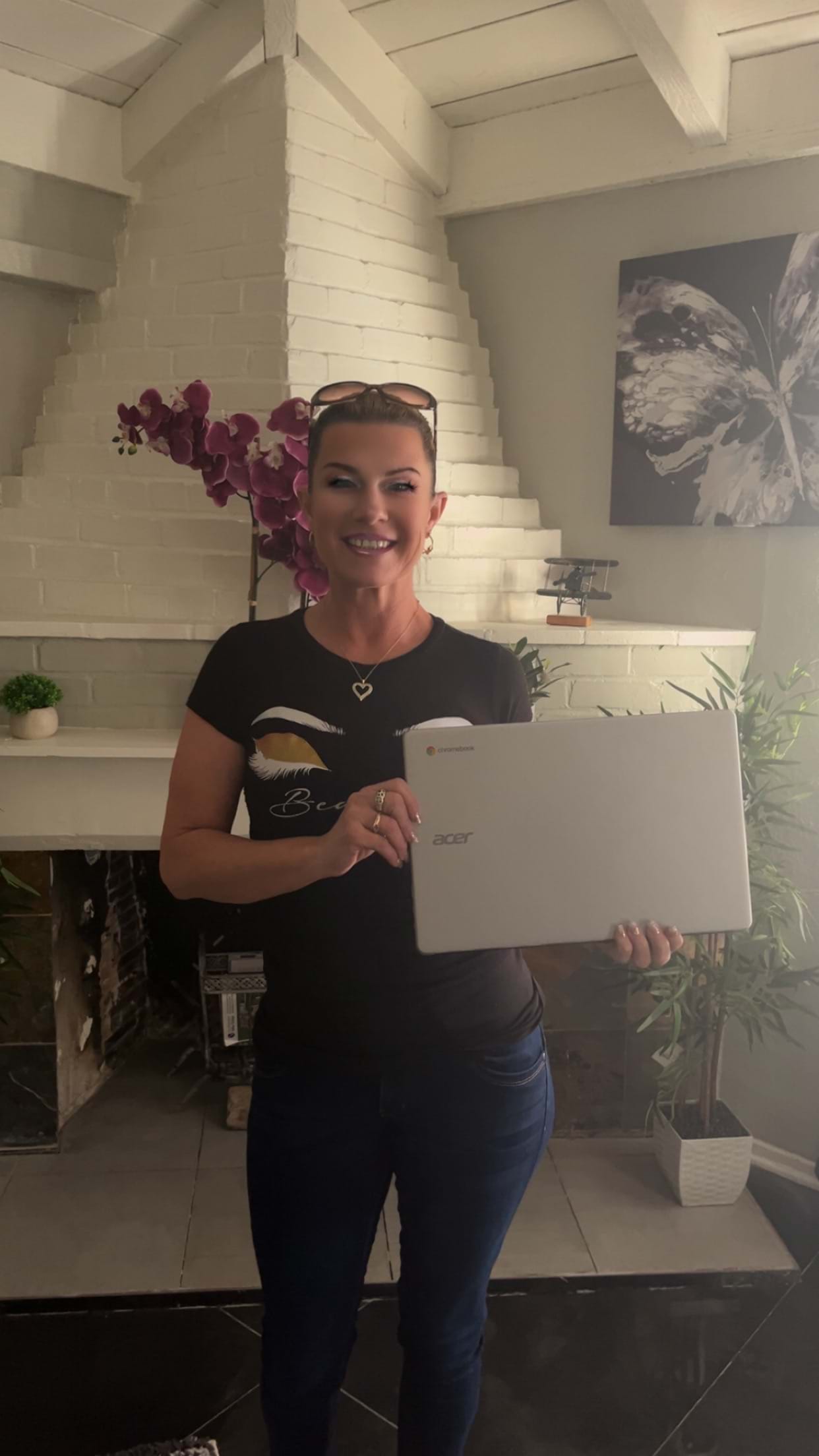 Rayne receives a Chromebook from Defy as a program graduate